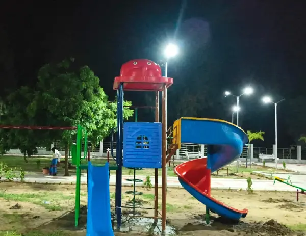 Children playing on a colorful playground slide and climbing structure